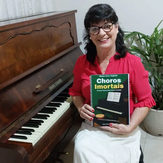 Cliente com o livro Choros Imortais ao lado do piano